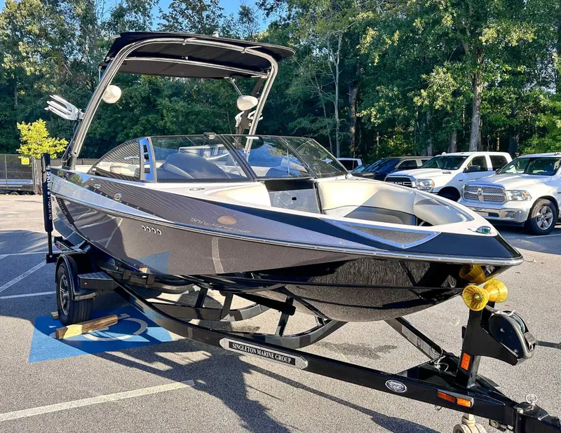 Slide: The Image of 2013 Malibu Wakesetter 20 VTX boat on trailer outdoors. - 5