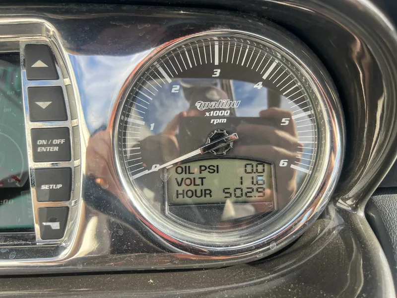 Slide: The Image of 2011 Malibu Wakesetter 23 LSV dashboard with tachometer and gauges. - 18