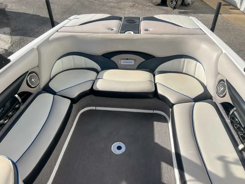 Slide: The Image of Interior of a 2011 Malibu Wakesetter 23 LSV boat with cushioned seating. - 23