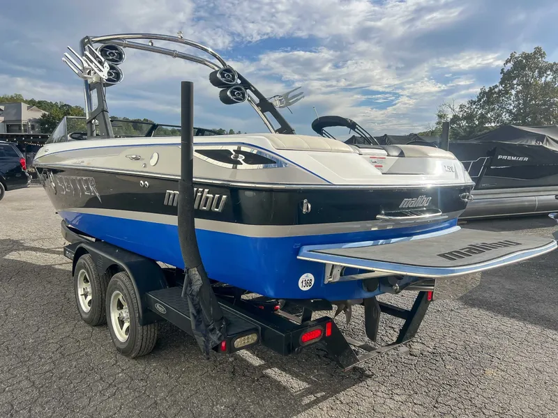 Slide: The Image of 2011 Malibu Wakesetter 23 LSV on trailer, blue and black, parked outdoors. - 8