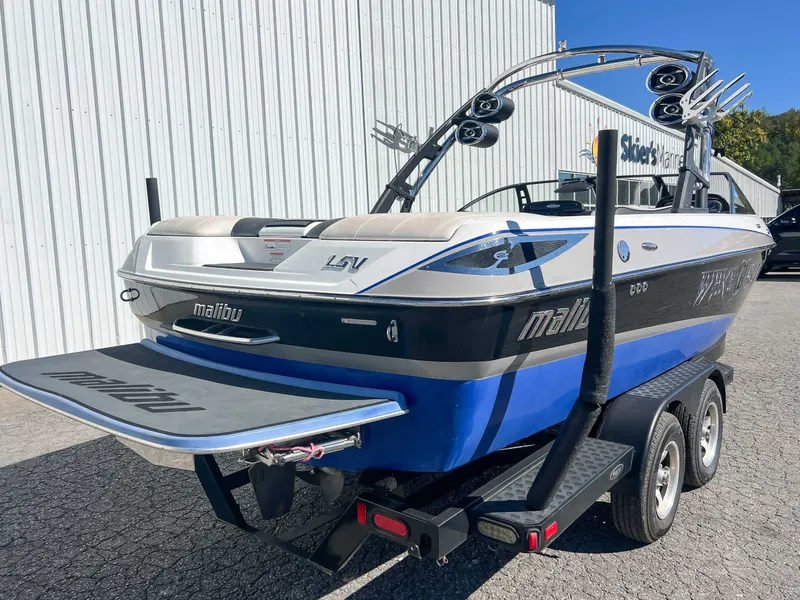 Slide: The Image of 2011 Malibu Wakesetter 23 LSV boat on trailer, blue and black, at Siler's Marine. - 9