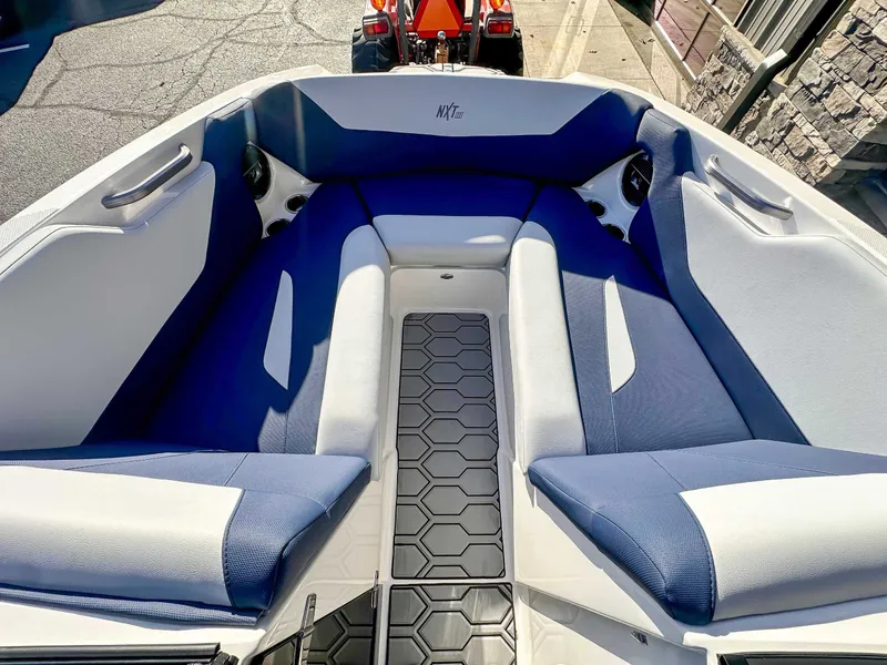 Slide: The Image of Interior of 2021 MasterCraft NXT22 boat with blue and gray seating. - 10