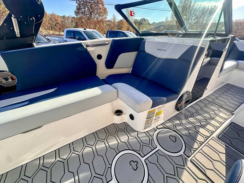 Slide: The Image of Interior of a 2021 MasterCraft NXT22 boat with blue seating. - 12