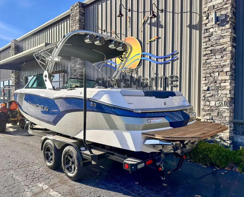 Slide: The Image of 2021 MasterCraft NXT22 boat parked outside a building. - 5