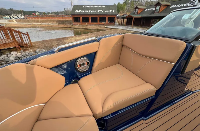 Slide: The Image of 2021 MasterCraft XT22 boat with beige seats and speaker. - 14