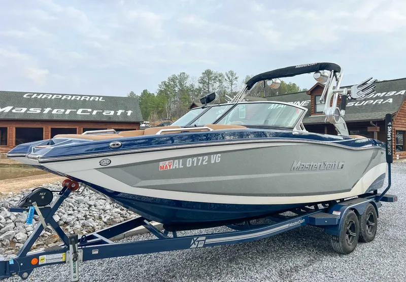 Slide: The Image of 2021 MasterCraft XT22 boat on trailer in front of showroom. - 3