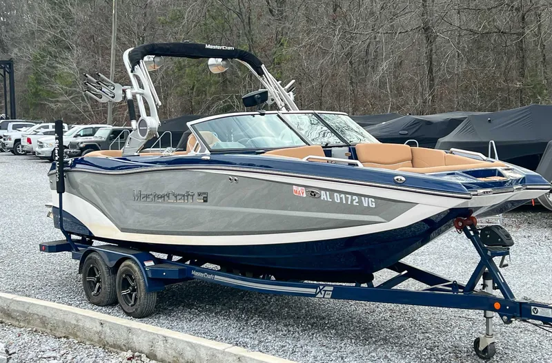 Slide: The Image of 2021 MasterCraft XT22 boat parked on trailer outdoors. - 5