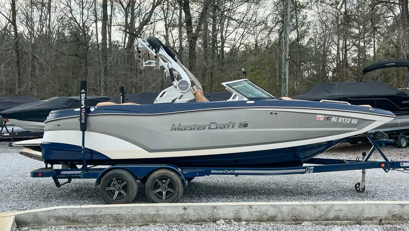 Slide: The Image of 2021 MasterCraft XT22 boat parked on trailer outdoors. - 6