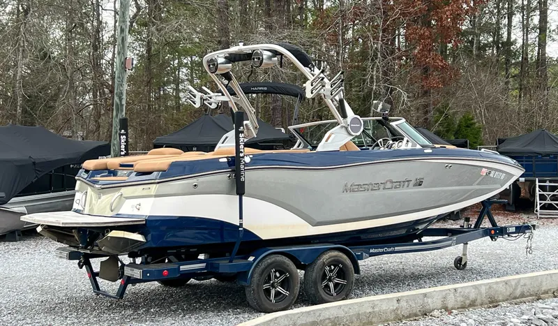 Slide: The Image of 2021 MasterCraft XT22 boat parked on trailer outdoors. - 7