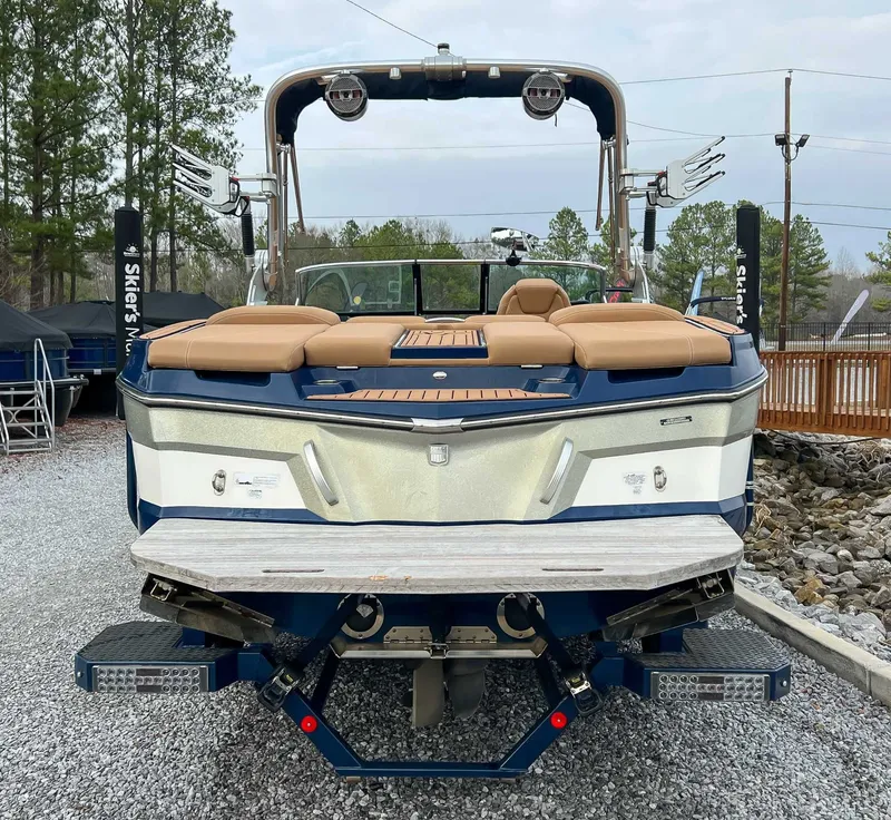 Slide: The Image of Rear view of a 2021 MasterCraft XT22 boat on gravel. - 9