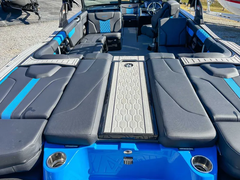 Slide: The Image of 2024 MasterCraft XT24 boat with luxurious interior and blue accents. - 11