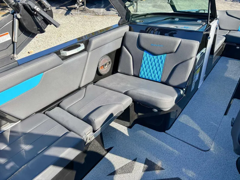Slide: The Image of 2024 MasterCraft XT24 interior with gray and blue seating. - 21