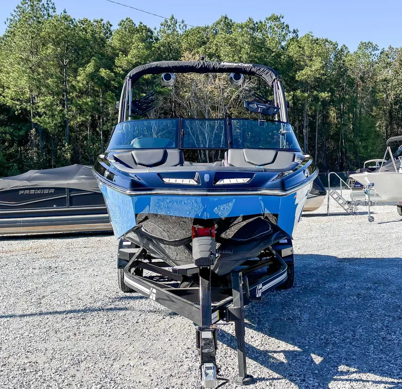 Slide: The Image of 2024 MasterCraft XT24 boat on trailer outdoors. - 4