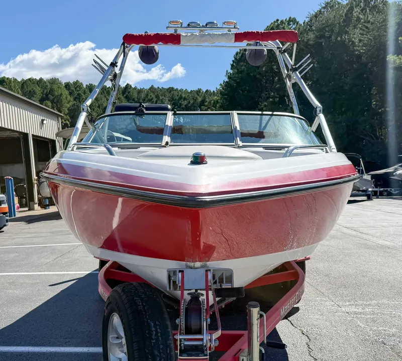 Slide: The Image of Red 2002 MasterCraft X30 boat on trailer outdoors. - 4
