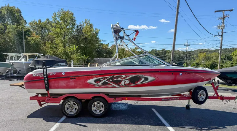 Slide: The Image of 2002 MasterCraft X30 boat parked on trailer outdoors. - 6