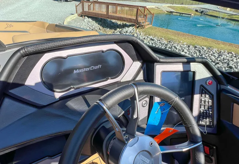 Slide: The Image of Interior view of 2024 MasterCraft XStarS boat with steering wheel and dashboard. - 15