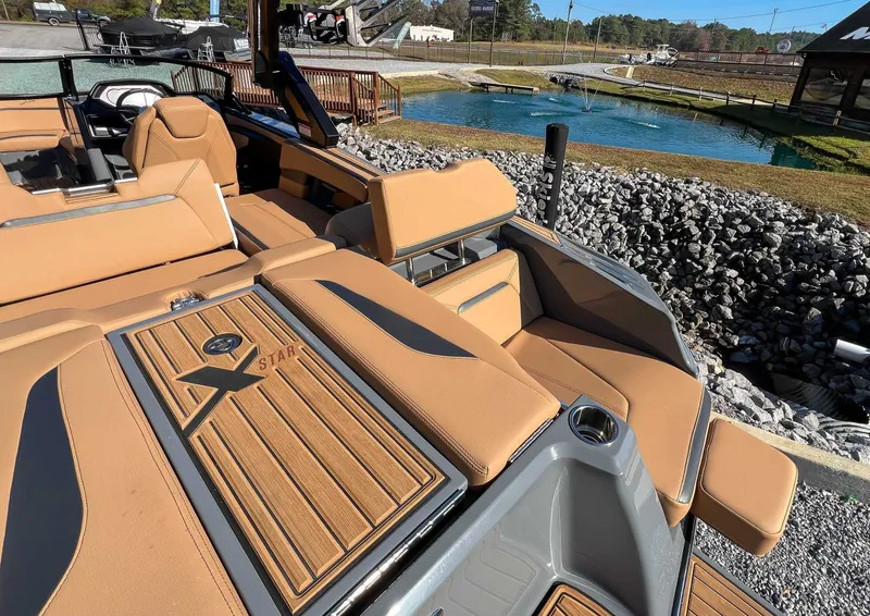 Slide: The Image of 2024 MasterCraft XStarS boat with luxurious interior and teak wood details. - 17