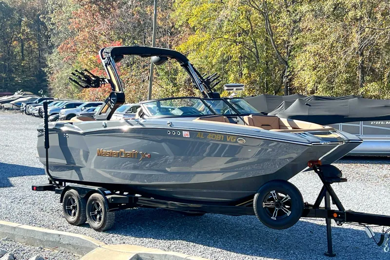 Slide: The Image of 2024 MasterCraft XStarS boat on trailer parked outdoors. - 3