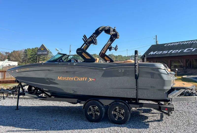 Slide: The Image of 2024 MasterCraft XStarS boat on trailer outdoors. - 6