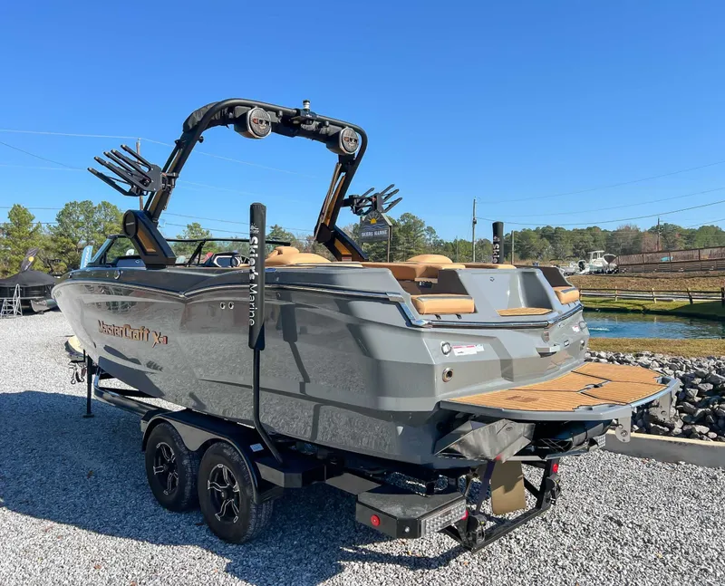 Slide: The Image of 2024 MasterCraft XStarS boat on trailer, gray color, displayed outdoors. - 7