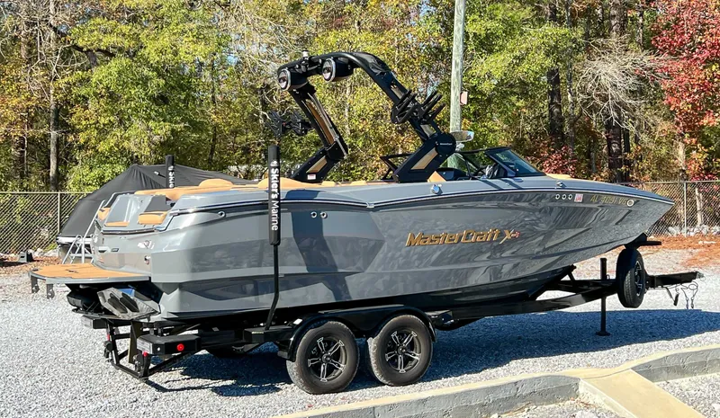 Slide: The Image of 2024 MasterCraft XStarS boat on trailer outdoors. - 8