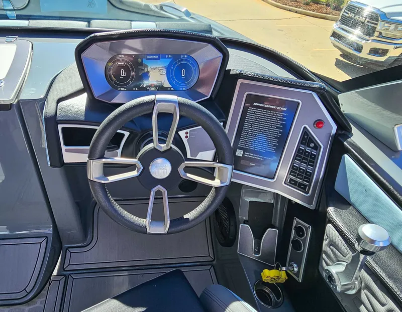 Slide: The Image of 2023 MasterCraft X26 boat cockpit with modern steering and display. - 15
