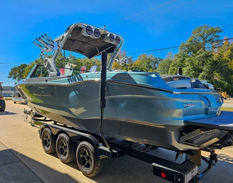 Slide: The Image of 2023 MasterCraft X26 boat on trailer, sunny day. - 7