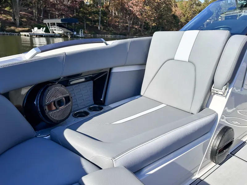 Slide: The Image of 2024 MasterCraft X24 interior with gray upholstery and speakers. - 14