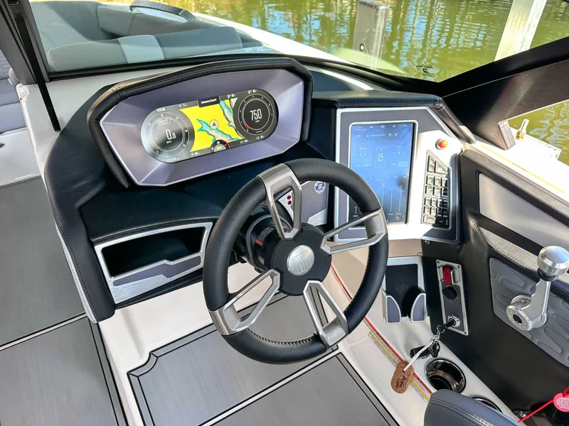 Slide: The Image of 2024 MasterCraft X24 boat cockpit with modern steering and display. - 19