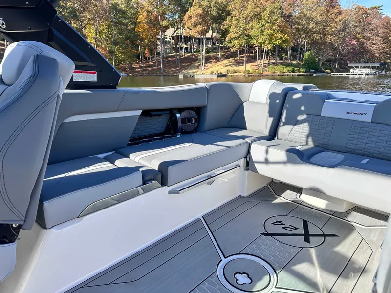 Slide: The Image of Interior of 2024 MasterCraft X24 boat with gray seating. - 23