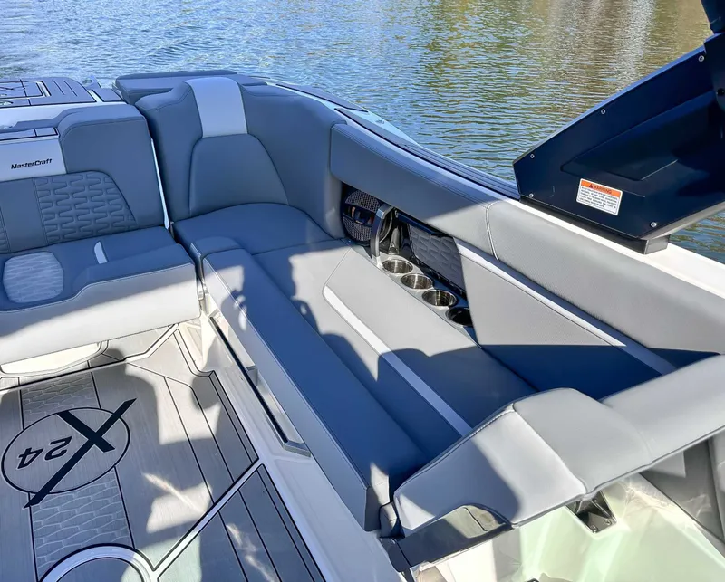 Slide: The Image of Interior of 2024 MasterCraft X24 with gray seating and cup holders. - 25