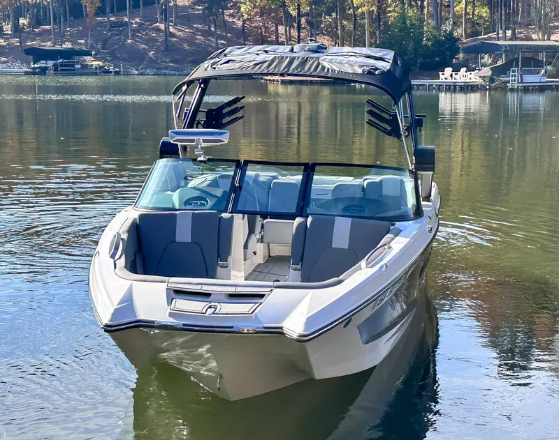 Slide: The Image of 2024 MasterCraft X24 boat on a serene lake. - 4