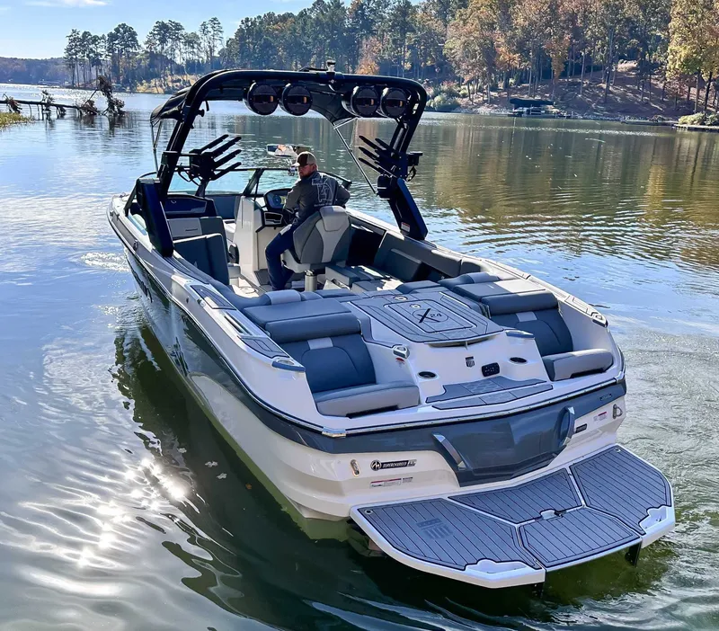 Slide: The Image of 2024 MasterCraft X24 boat on a serene lake. - 7