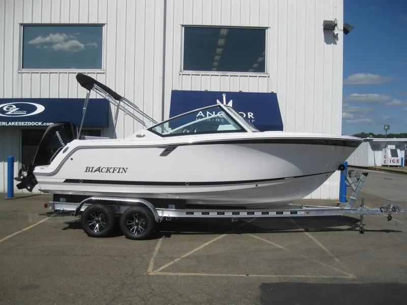 The Image of 2024 Blackfin 232 DC boat displayed in showroom, side view. - 0