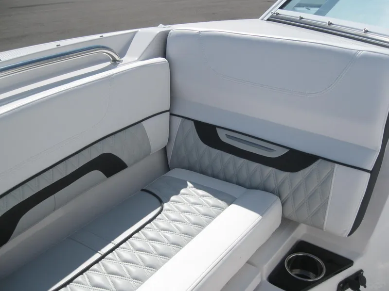 Slide: The Image of 2024 Blackfin 232 DC interior cabin with white seating and black door. - 22