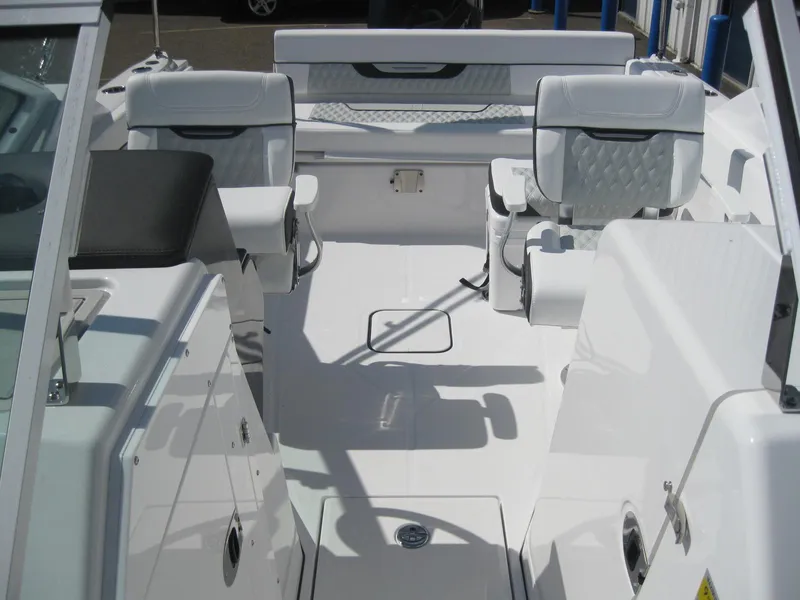 Slide: The Image of 2024 Blackfin 232 DC boat interior with white and gray seating. - 23