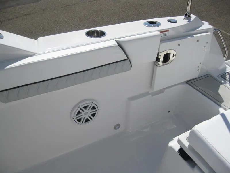 Slide: The Image of 2024 Blackfin 232 DC boat interior with white and gray quilted seating. - 24
