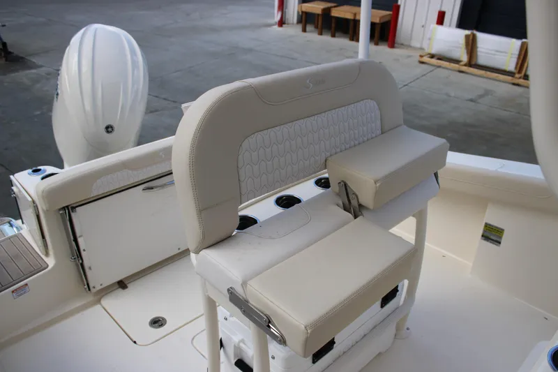 Slide: The Image of 2026 Scout 220 XSF boat interior with cushioned seating and cup holders. - 11