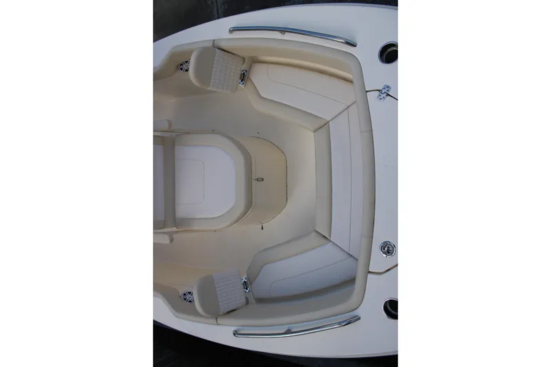 Slide: The Image of 2026 Scout 220 XSF boat interior with beige seating and stainless steel accents. - 13