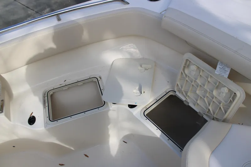 Slide: The Image of 2026 Scout 220 XSF boat interior with open storage compartments. - 15