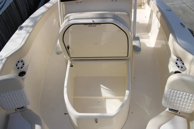 Slide: The Image of 2026 Scout 220 XSF boat interior with open storage compartment and seating. - 16