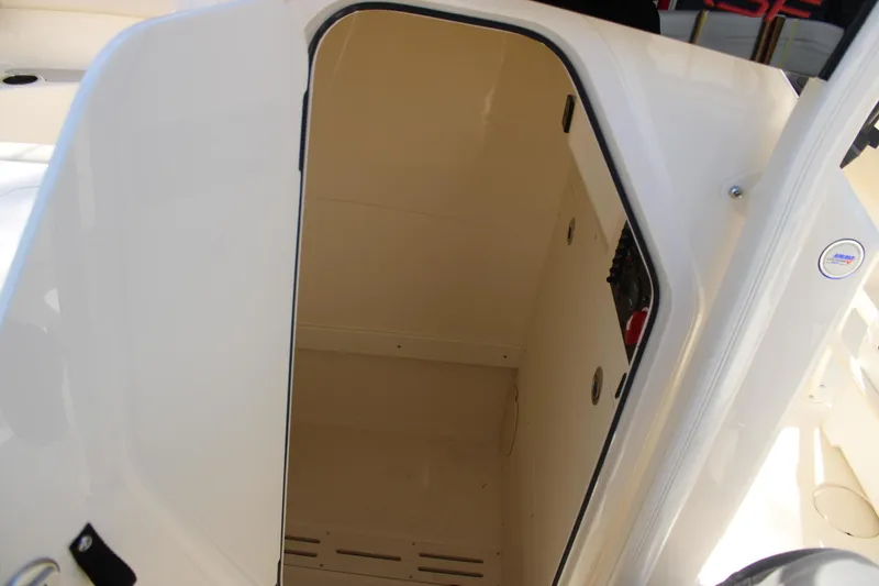 Slide: The Image of 2026 Scout 220 XSF boat storage compartment, open door view. - 17