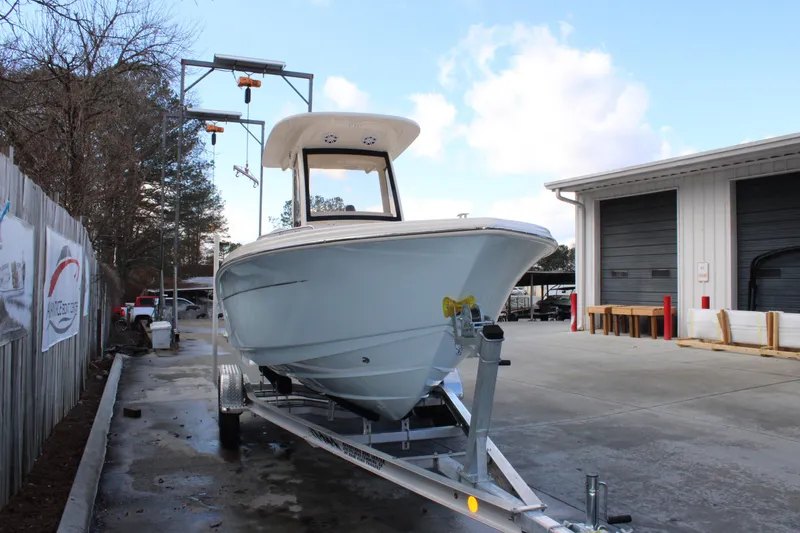 Slide: The Image of 2026 Scout 220 XSF boat on trailer in outdoor storage area. - 4