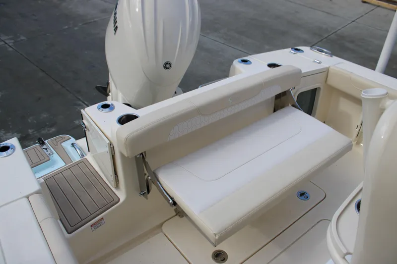 Slide: The Image of 2026 Scout 220 XSF boat interior with foldable seating and cup holders. - 8