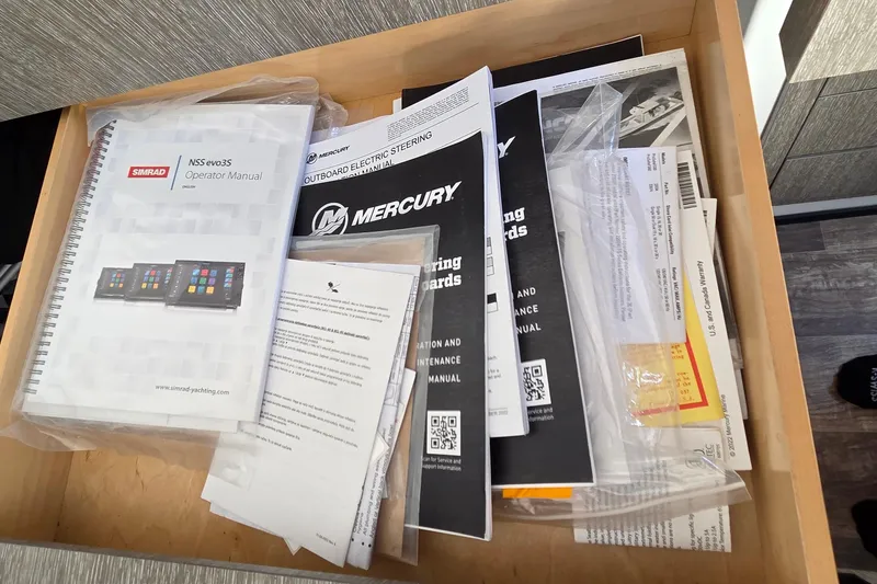 Slide: The Image of Drawer containing manuals and documents for a 2024 Monterey 385SS Super Sport boat. - 19