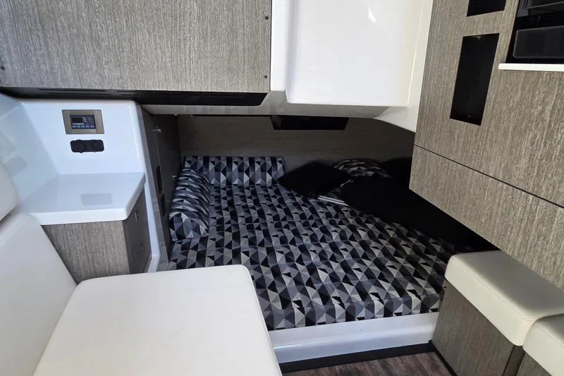 Slide: The Image of 2024 Monterey 385SS Super Sport cabin interior with modern bedding and sleek cabinetry. - 23