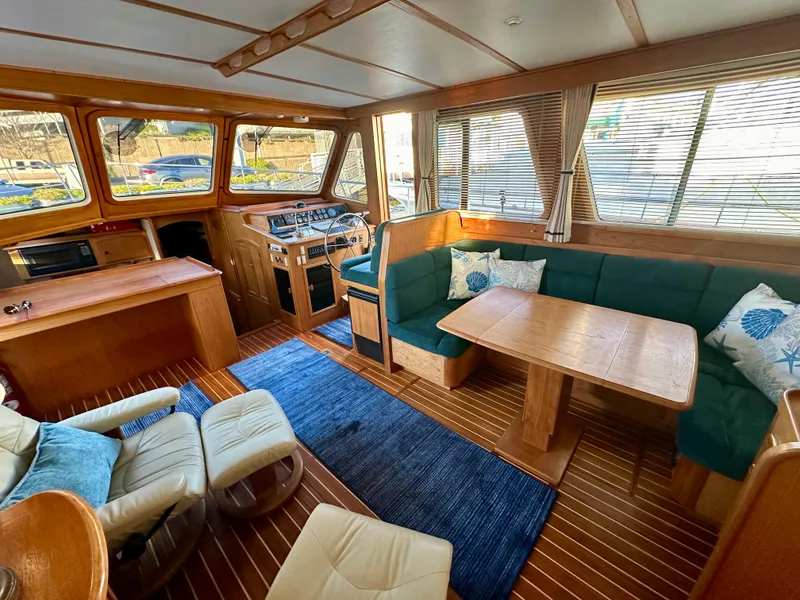 Slide: The Image of Interior of 1997 Sabre Cockpit Motor Yacht with wood finish and green seating. - 17