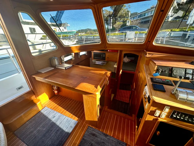 Slide: The Image of 1997 Sabre Cockpit Motor Yacht interior with wooden finishes and navigation equipment. - 18