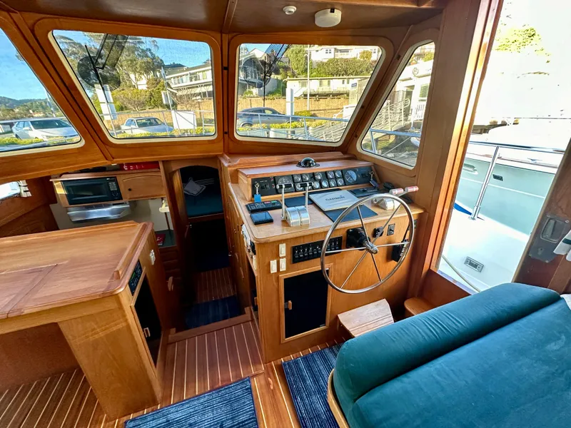 Slide: The Image of 1997 Sabre Cockpit Motor Yacht interior with wooden dashboard and steering wheel. - 19