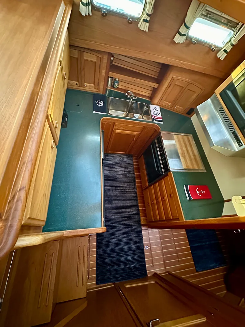 Slide: The Image of Interior of 1997 Sabre Cockpit Motor Yacht with wood cabinetry and compact kitchen. - 20